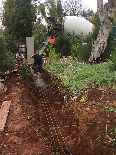 Landscaping construction - pouring concrete for boundary wall